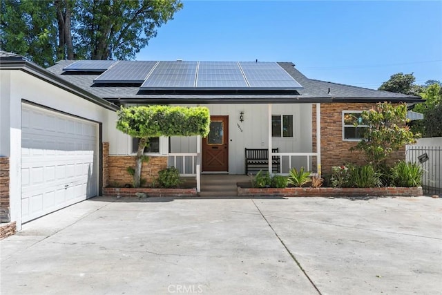 6454 Baird Ave, Reseda, CA 91335 - single story home featuring covered porch, concrete driveway, an attached garage, roof mounted solar panels, and a shingled roof