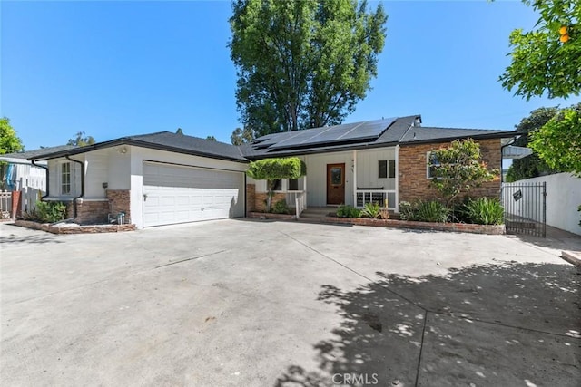 6454 Baird Ave, Reseda, CA 91335 - ranch-style house with stone siding, a porch, concrete driveway, and an attached garage