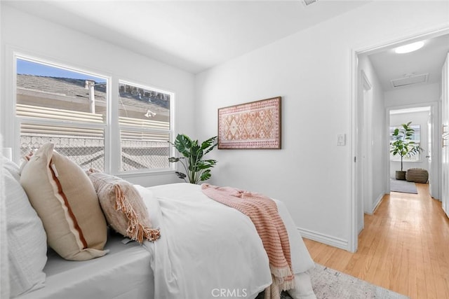 6454 Baird Ave, Reseda, CA 91335 - bedroom featuring light wood finished floors, baseboards, and attic access
