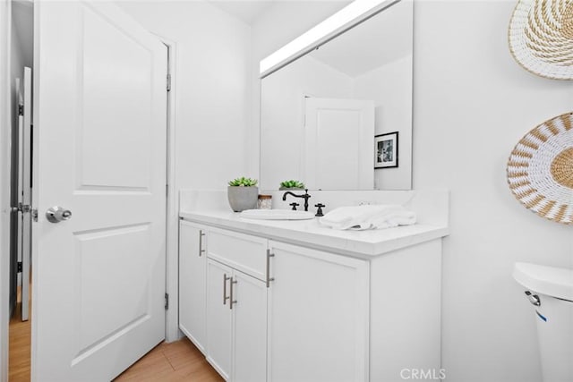 6454 Baird Ave, Reseda, CA 91335 - half bathroom featuring vanity, wood finished floors, and toilet