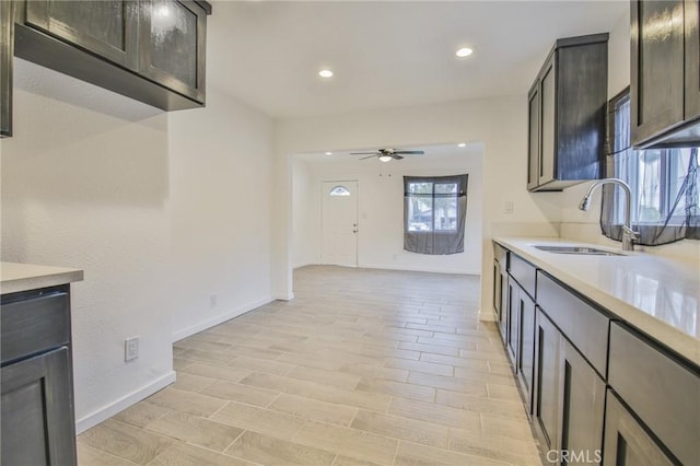 343 E 98th St, Los Angeles, CA 90003 - kitchen with a sink, a ceiling fan, light countertops, baseboards, and recessed lighting