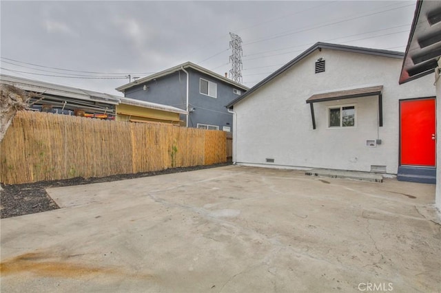 343 E 98th St, Los Angeles, CA 90003 - view of side of property featuring fence, stucco siding, and a patio area