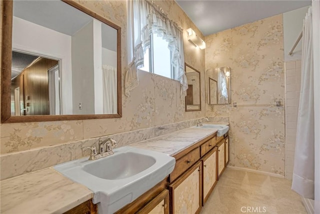 bathroom featuring wallpapered walls, double vanity, and a shower with shower curtain