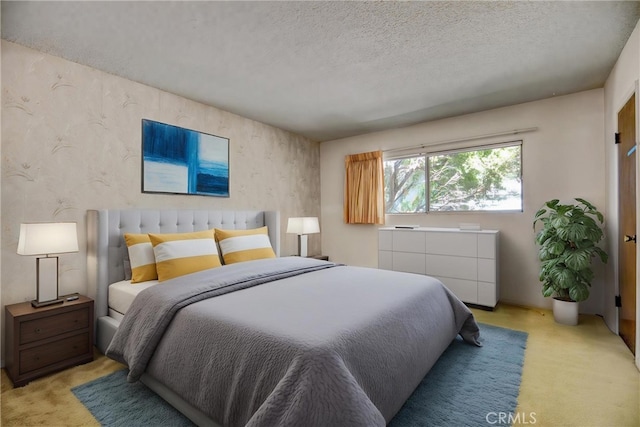 bedroom with carpet flooring, a textured ceiling, and wallpapered walls