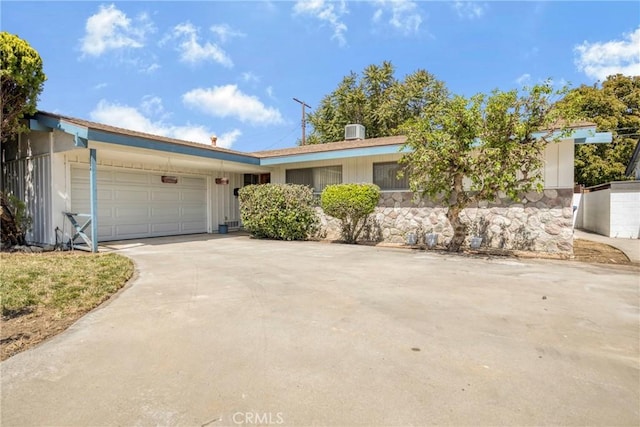 ranch-style house with an attached garage and driveway