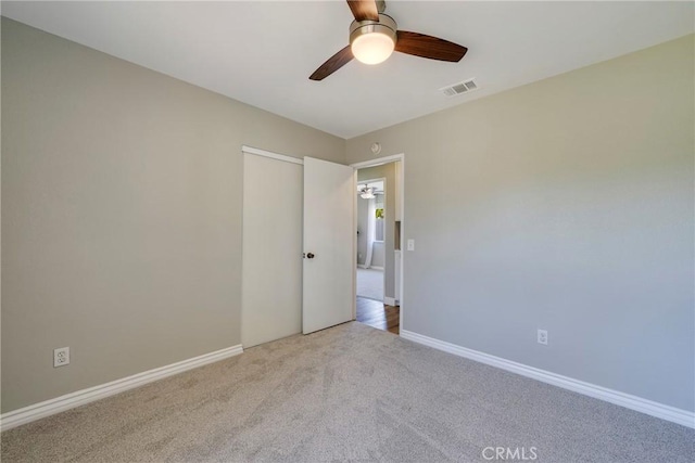 spare room featuring carpet flooring, a ceiling fan, and baseboards