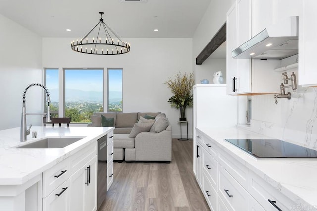 239 Futurity Ln, Fallbrook, CA 92028 - kitchen with ventilation hood, black electric cooktop, light wood finished floors, white cabinets, and recessed lighting