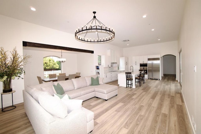 239 Futurity Ln, Fallbrook, CA 92028 - living room with a chandelier, light wood-type flooring, recessed lighting, and arched walkways
