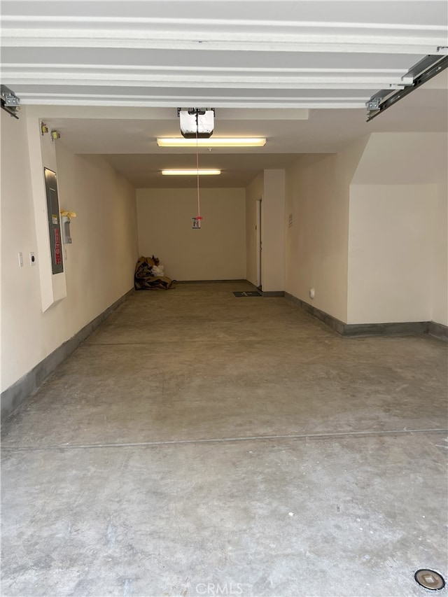 garage featuring a garage door opener and electric panel