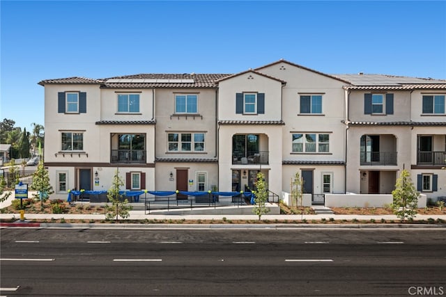 multi unit property featuring stucco siding and a tile roof