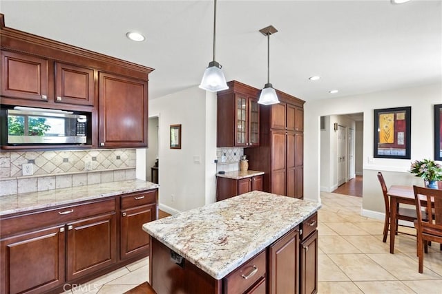 63 Our Way, Chico, CA 95973 - kitchen featuring stainless steel microwave, tasteful backsplash, light tile patterned flooring, baseboards, and recessed lighting