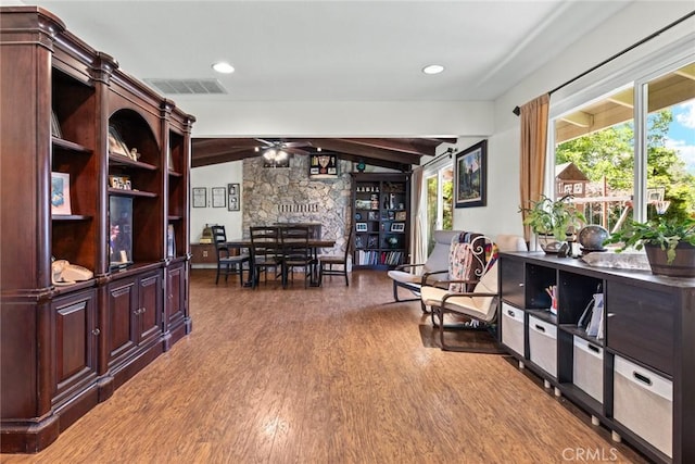63 Our Way, Chico, CA 95973 - sitting room featuring ceiling fan, wood finished floors, vaulted ceiling, and a stone fireplace