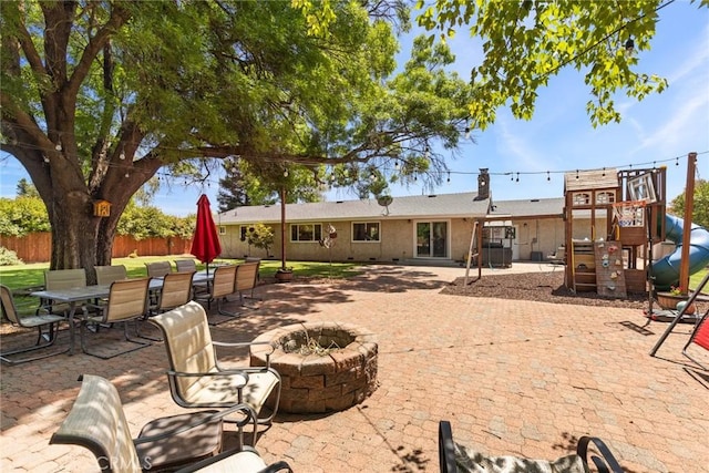 63 Our Way, Chico, CA 95973 - back of house with a fire pit, a patio area, a playground, and outdoor dining area