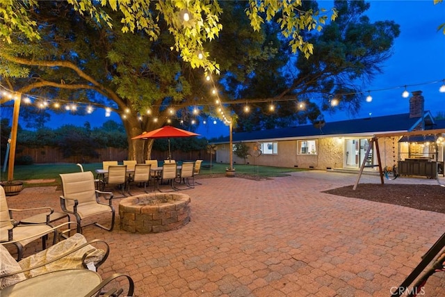 63 Our Way, Chico, CA 95973 - patio at twilight featuring an outdoor fire pit, a patio, and outdoor dining space
