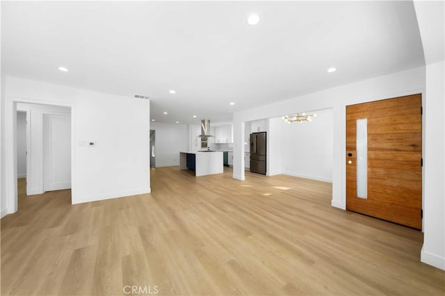 6916 Etiwanda Ave, Reseda, CA 91335 - unfurnished living room featuring a chandelier, recessed lighting, light wood-style floors, and baseboards