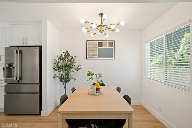 6916 Etiwanda Ave, Reseda, CA 91335 - dining room featuring a chandelier, baseboards, and light wood-style flooring