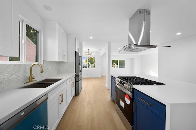 6916 Etiwanda Ave, Reseda, CA 91335 - kitchen with stainless steel appliances, wall chimney range hood, a sink, white cabinets, and light wood finished floors