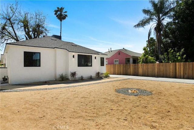 6916 Etiwanda Ave, Reseda, CA 91335 - back of property with fence, stucco siding, and a shingled roof