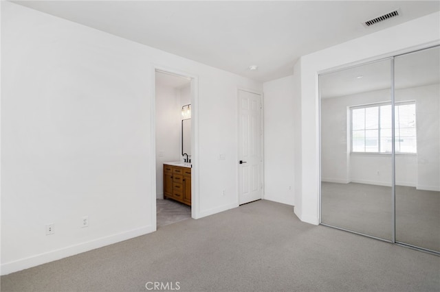 35987 Corte Renata, Murrieta, CA 92562 - unfurnished bedroom featuring light carpet, a sink, a closet, baseboards, and ensuite bathroom