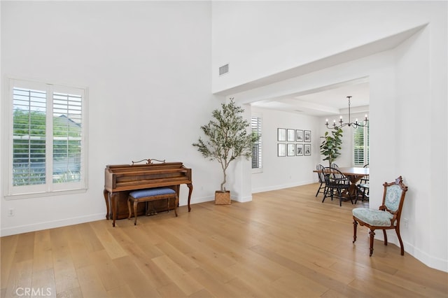 35987 Corte Renata, Murrieta, CA 92562 - living area with a chandelier, light wood-type flooring, and baseboards