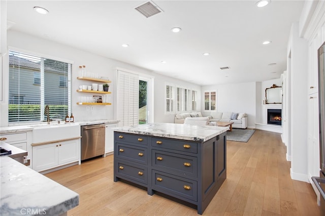 35987 Corte Renata, Murrieta, CA 92562 - kitchen with dishwasher, white cabinets, light wood finished floors, a lit fireplace, and recessed lighting