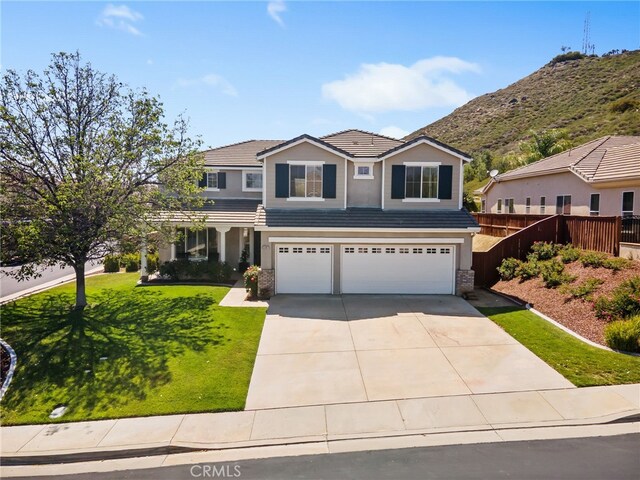 35987 Corte Renata, Murrieta, CA 92562 - traditional-style house featuring a garage, a tile roof, concrete driveway, stucco siding, and stone siding