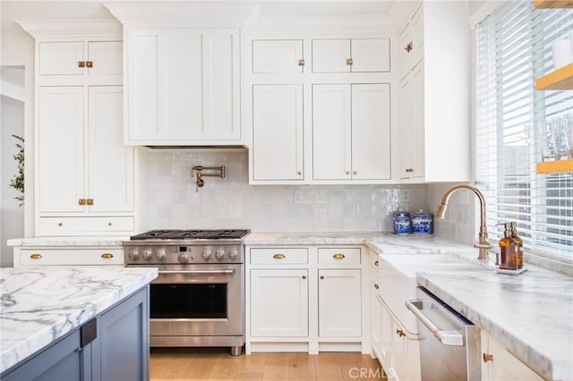 35987 Corte Renata, Murrieta, CA 92562 - kitchen with stainless steel appliances, plenty of natural light, white cabinetry, and decorative backsplash