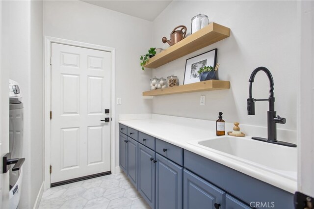 35987 Corte Renata, Murrieta, CA 92562 - kitchen with blue cabinetry, a sink, open shelves, light countertops, and baseboards