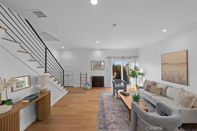 1006 Palm Ln, Redondo Beach, CA 90278 - living area with stairway, light wood-style flooring, recessed lighting, a brick fireplace, and ornamental molding