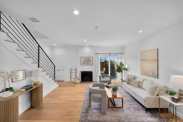 1006 Palm Ln, Redondo Beach, CA 90278 - living room with stairway, light wood-style floors, a brick fireplace, baseboards, and recessed lighting