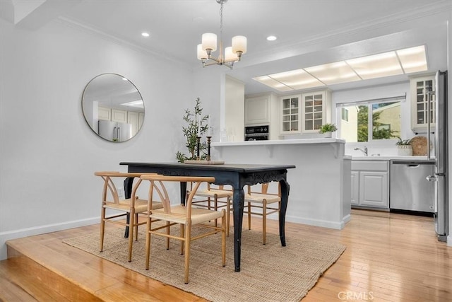 1006 Palm Ln, Redondo Beach, CA 90278 - dining space with light wood-style floors, a chandelier, ornamental molding, recessed lighting, and baseboards