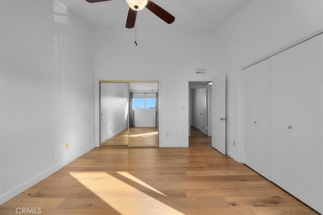 1006 Palm Ln, Redondo Beach, CA 90278 - unfurnished bedroom with multiple closets, wood finished floors, baseboards, and a ceiling fan