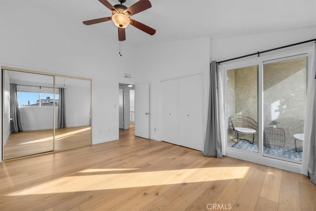 1006 Palm Ln, Redondo Beach, CA 90278 - unfurnished bedroom featuring two closets, access to outside, hardwood / wood-style flooring, ceiling fan, and baseboards