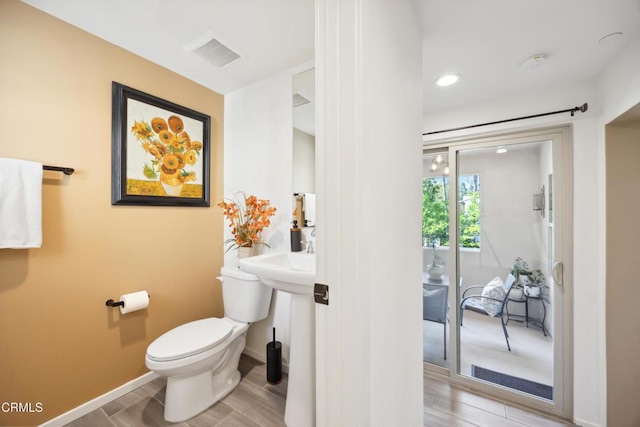 865 Orchid Way Unit A, Azusa, CA 91702 - bathroom featuring toilet, wood finished floors, and baseboards