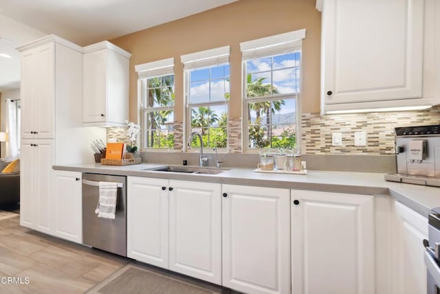 865 Orchid Way Unit A, Azusa, CA 91702 - kitchen with stainless steel dishwasher, a sink, light countertops, and white cabinets