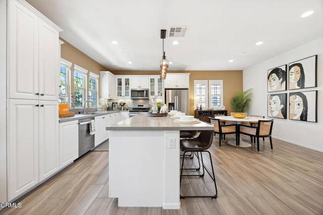 865 Orchid Way Unit A, Azusa, CA 91702 - kitchen with stainless steel appliances, healthy amount of natural light, a kitchen island, a breakfast bar area, and recessed lighting