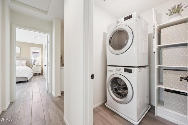 865 Orchid Way Unit A, Azusa, CA 91702 - washroom with stacked washing machine and dryer, wood tiled floors, and baseboards