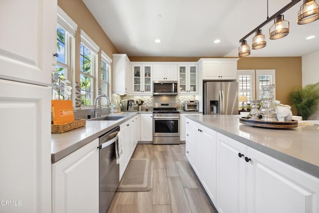865 Orchid Way Unit A, Azusa, CA 91702 - kitchen featuring stainless steel appliances, a sink, healthy amount of natural light, backsplash, and recessed lighting