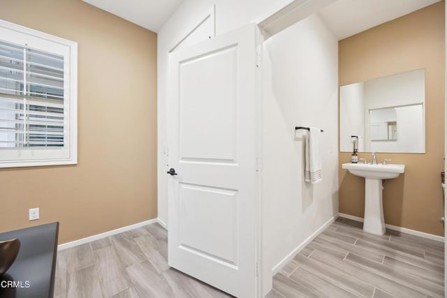 865 Orchid Way Unit A, Azusa, CA 91702 - bathroom with baseboards, wood finished floors, and a sink