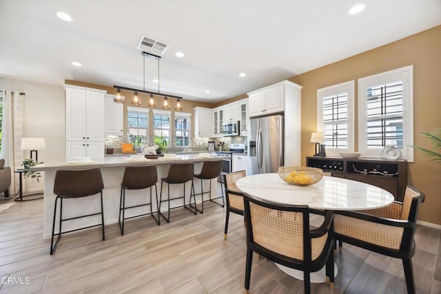 865 Orchid Way Unit A, Azusa, CA 91702 - dining room with recessed lighting, light wood-style floors, and baseboards