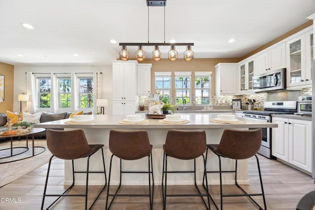 865 Orchid Way Unit A, Azusa, CA 91702 - kitchen with stainless steel appliances, recessed lighting, a breakfast bar, and white cabinets