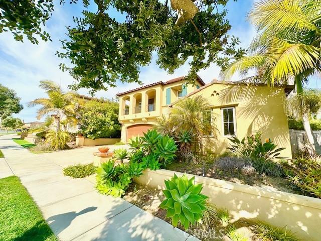 7148 Sitio Caliente, Carlsbad, CA 92009 - mediterranean / spanish home featuring stucco siding, an attached garage, and driveway