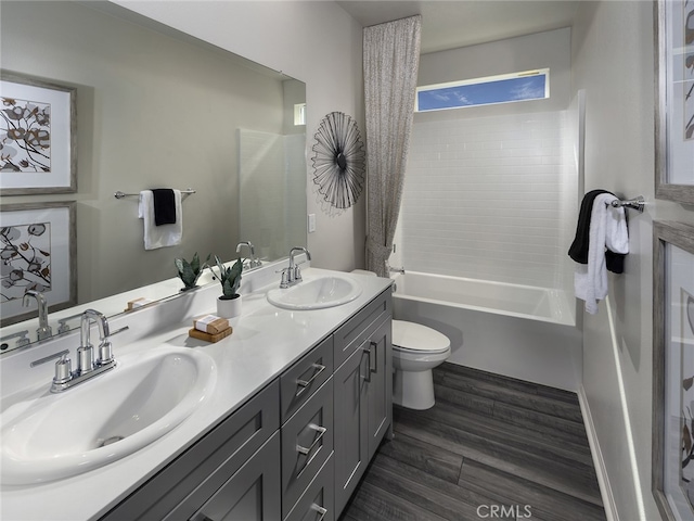 35221 Lopez Ln, Beaumont, CA 92223 - bathroom with toilet, double vanity, wood finished floors, and bathing tub / shower combination