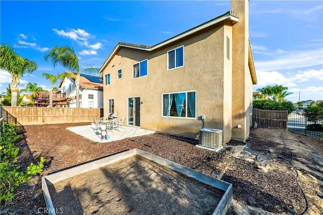 29288 Woodlea Ln, Menifee, CA 92584 - rear view of property featuring central AC unit, stucco siding, a patio, and a fenced backyard