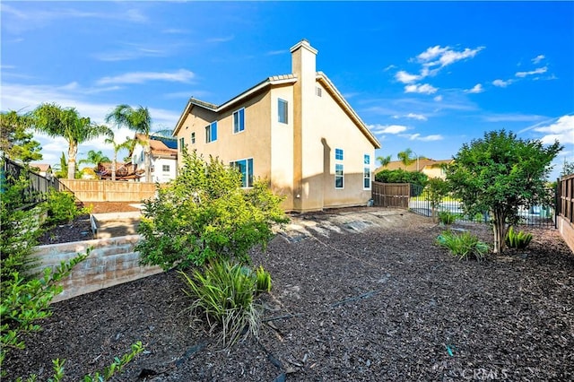 29288 Woodlea Ln, Menifee, CA 92584 - rear view of house featuring a fenced backyard and stucco siding