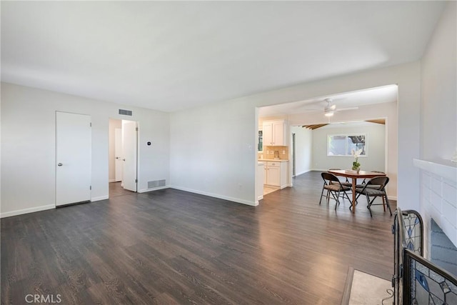 228 W Old Ml, Corona, CA 92882 - living room featuring dark wood-style flooring, a tiled fireplace, and ceiling fan