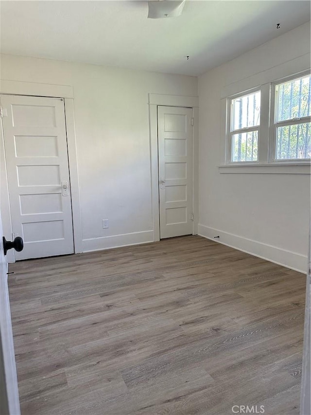 1073 Orizaba Ave, Long Beach, CA 90804 - unfurnished bedroom with baseboards and wood finished floors