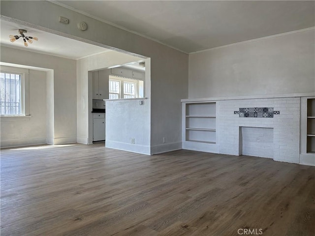 1073 Orizaba Ave, Long Beach, CA 90804 - unfurnished living room with wood finished floors, ornamental molding, built in shelves, baseboards, and a fireplace