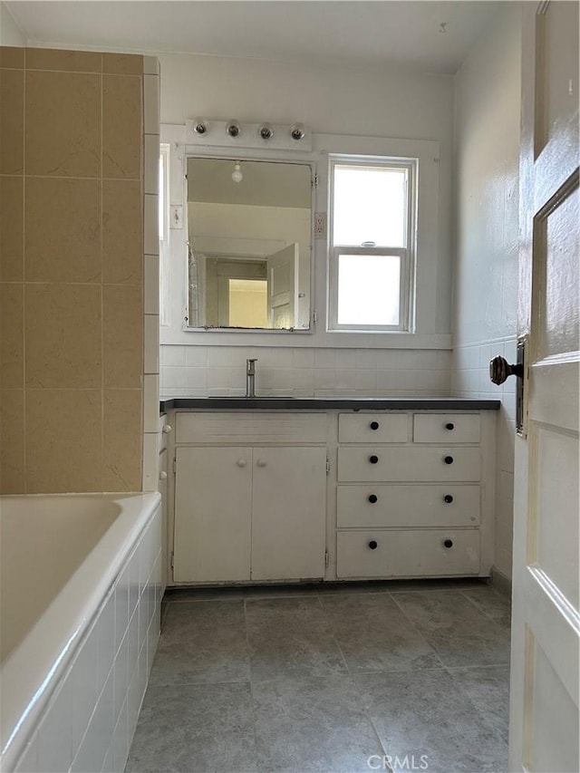 1073 Orizaba Ave, Long Beach, CA 90804 - full bathroom with a tub, vanity, and tile walls