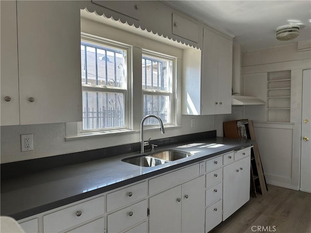 1073 Orizaba Ave, Long Beach, CA 90804 - kitchen featuring a sink, dark countertops, white cabinetry, and wood finished floors